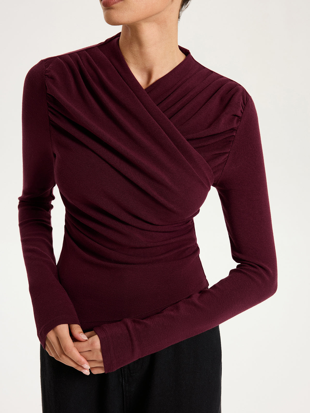 Emmanuelle burgundy draped crossover ruched knit top, close-up of the draped crossover front