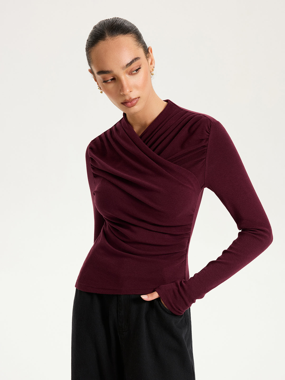 Emmanuelle burgundy draped crossover ruched knit top, side view of the waist ruching