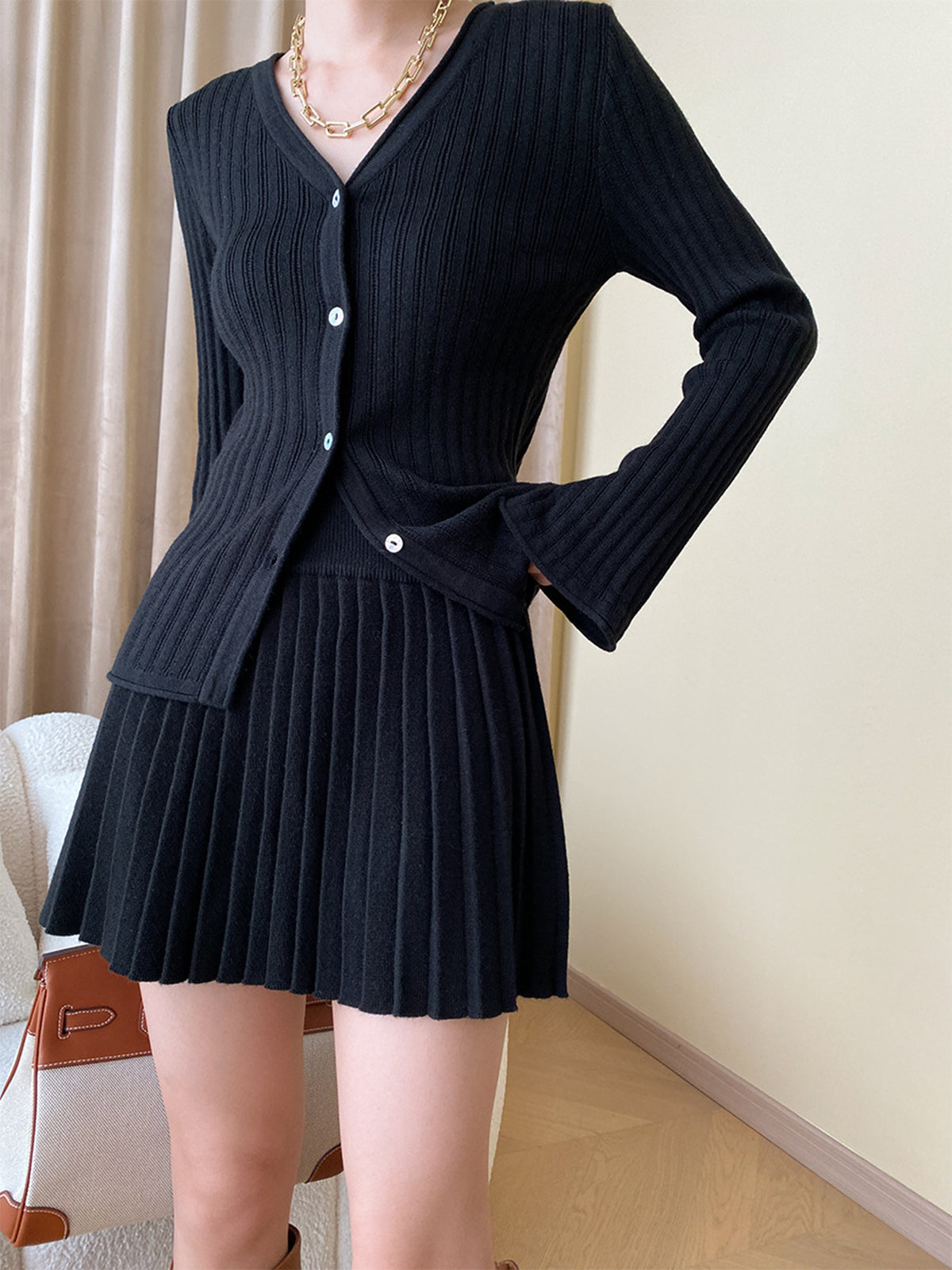 Eulalie black ribbed knit cardigan and pleated mini skirt set, front view on model