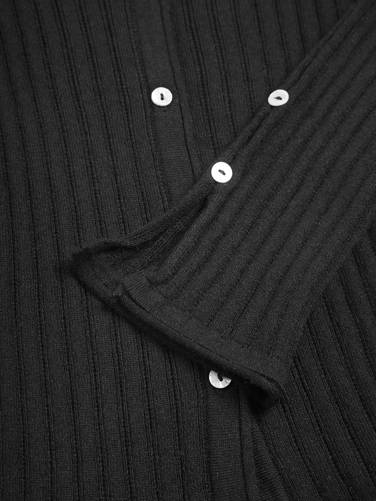Eulalie black ribbed knit cardigan, close-up of the shell buttons and flared cuff