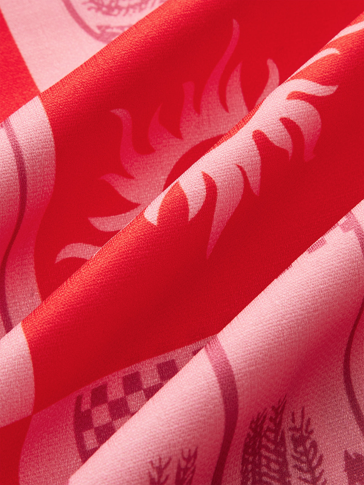 Faustine red and pink sun and palm print fabric, close-up