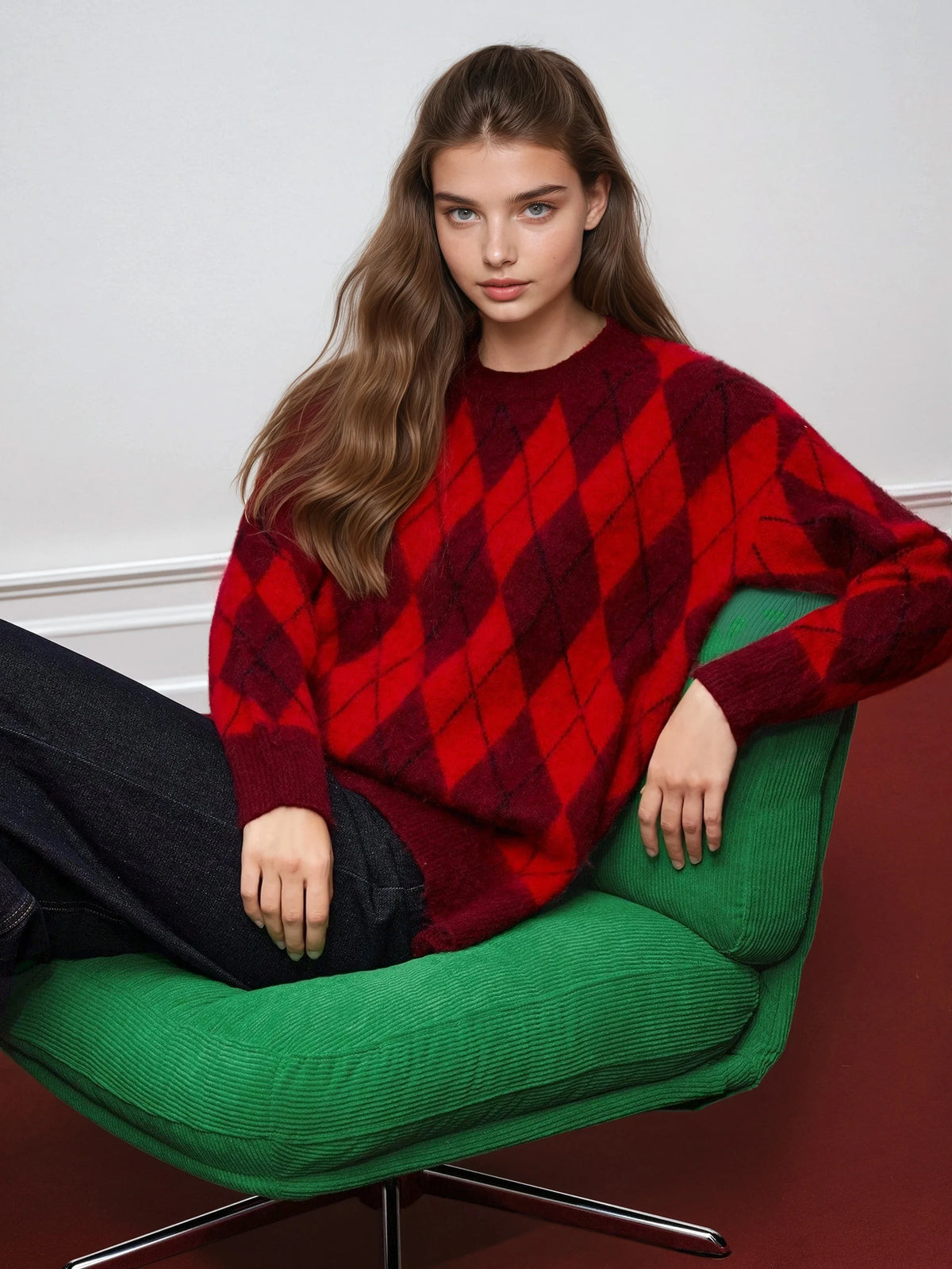 Faustine red argyle sweater shown seated, dropped shoulder visible