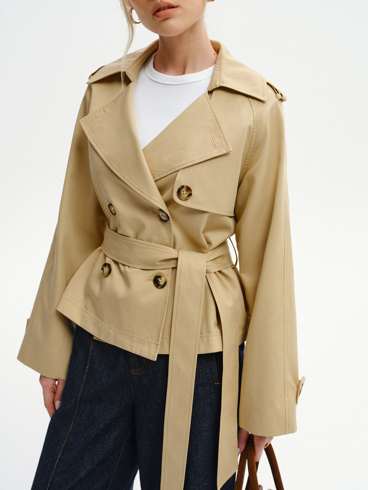 Khaki double-breasted trench jacket with the belt tied, front view