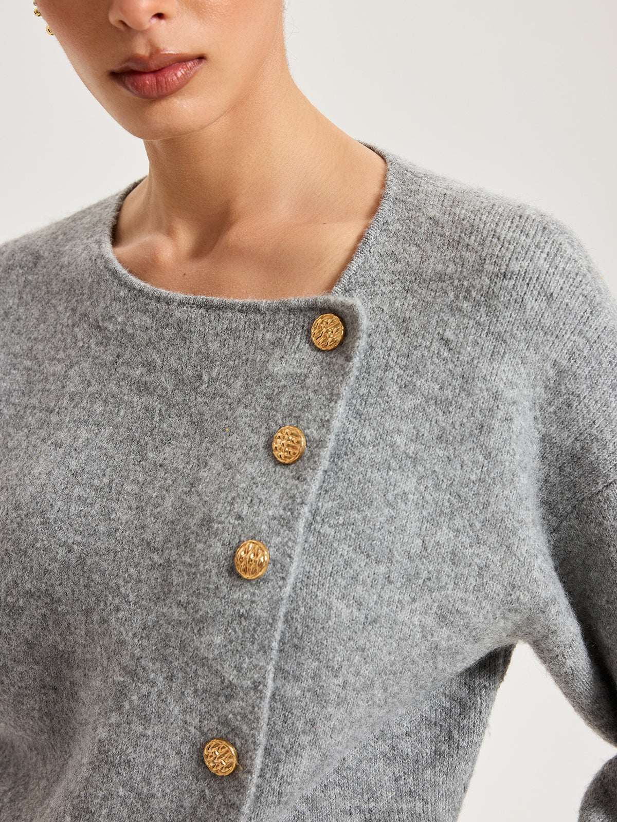 Genevieve gray asymmetric cardigan, close-up of the offset neckline and gold buttons