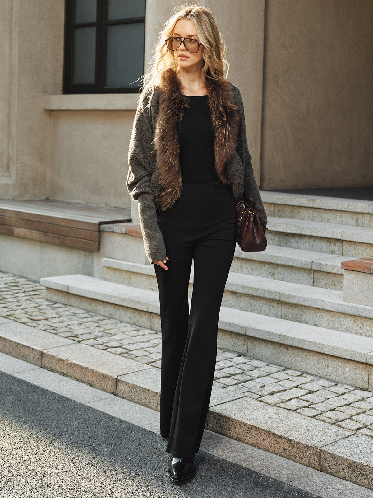 Georgette gray knit jacket with faux fur collar, full-length front view worn open over black pants