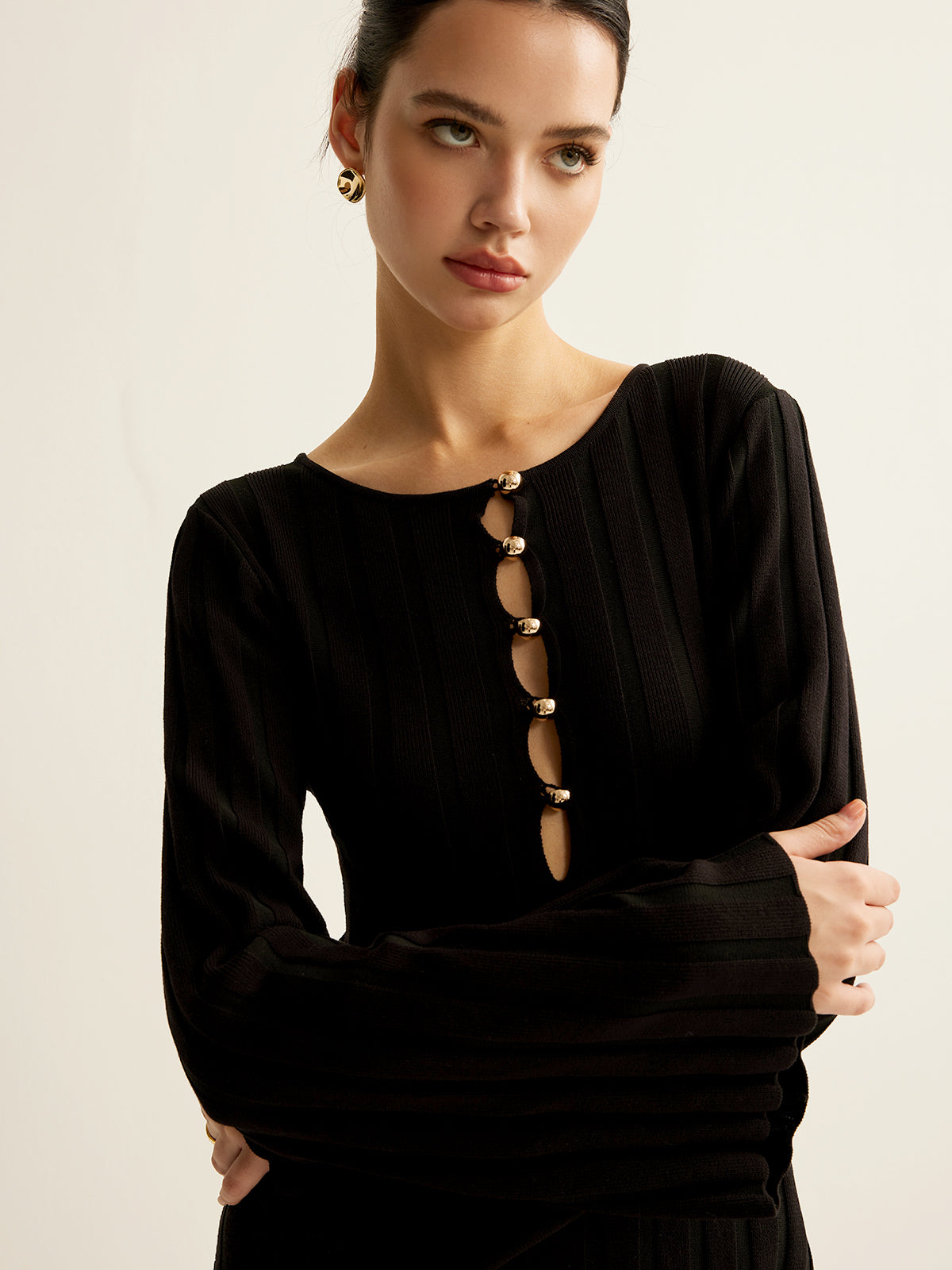 Germaine black ribbed maxi dress, close-up of the five gold buttons and open cut-outs