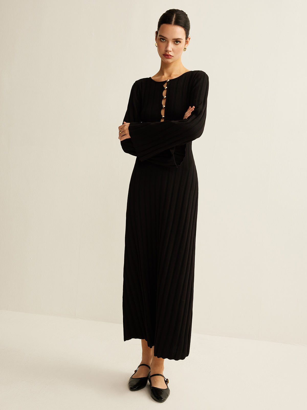 Germaine black ribbed maxi dress, full-length view showing the scalloped rib hem