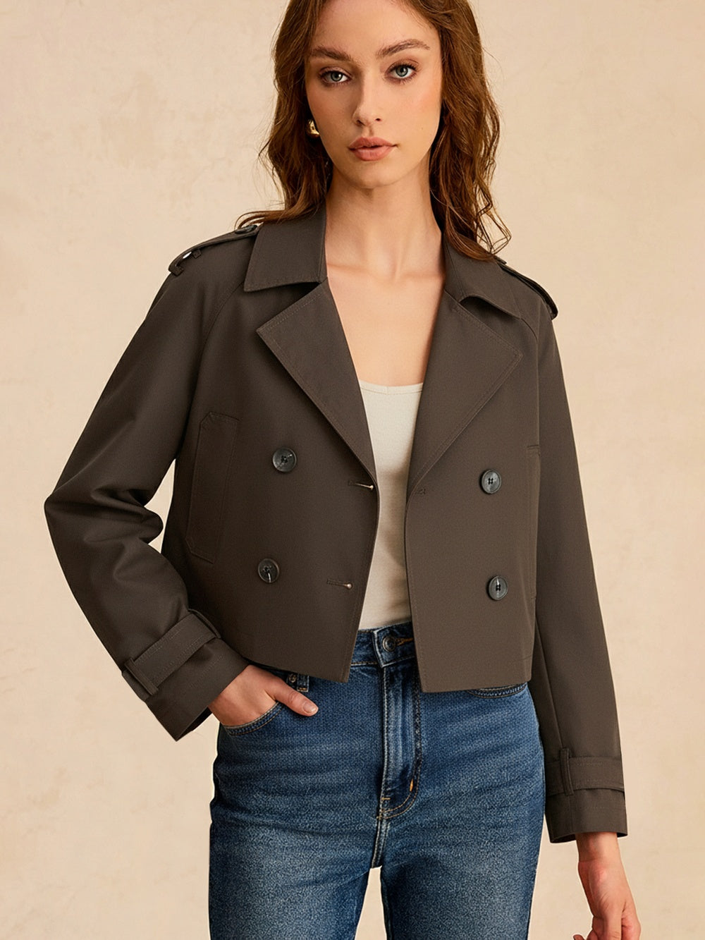 Brown cropped double-breasted jacket worn with jeans, front view
