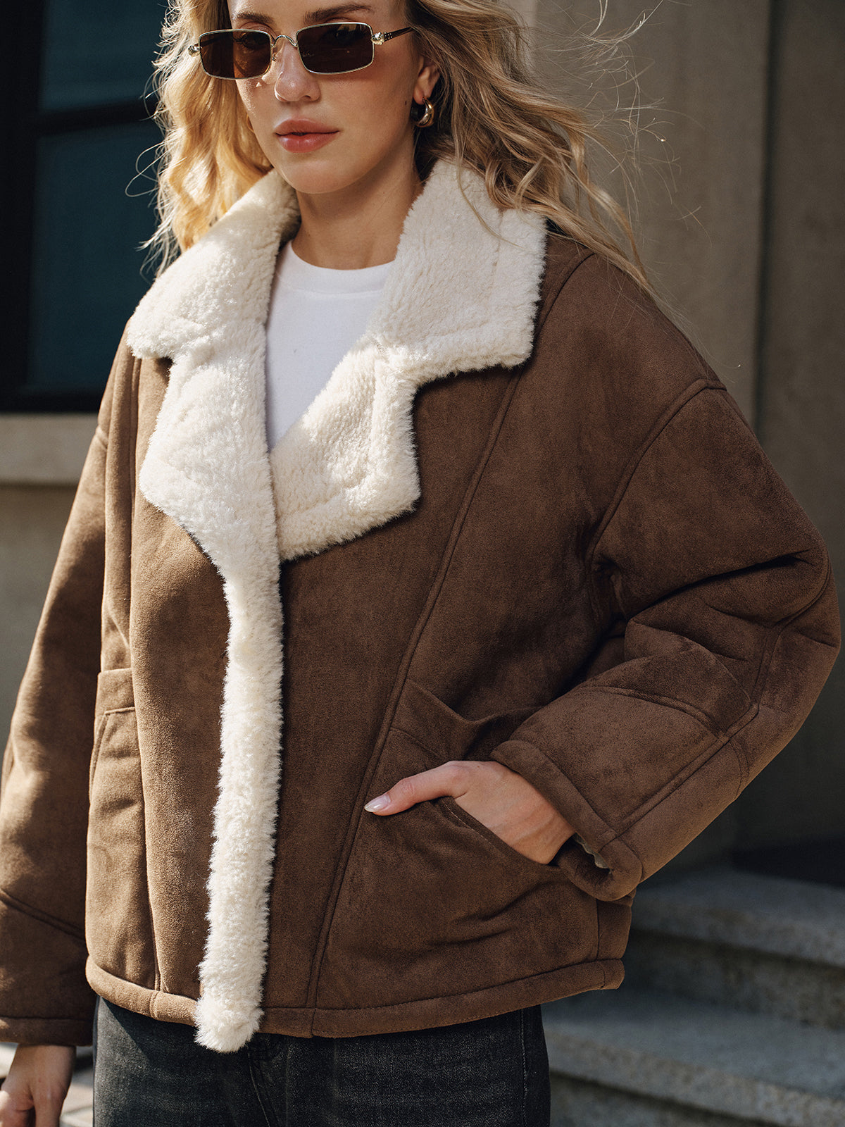 Irma Brown jacket, close-up of the slant welt hip pocket with a hand inside