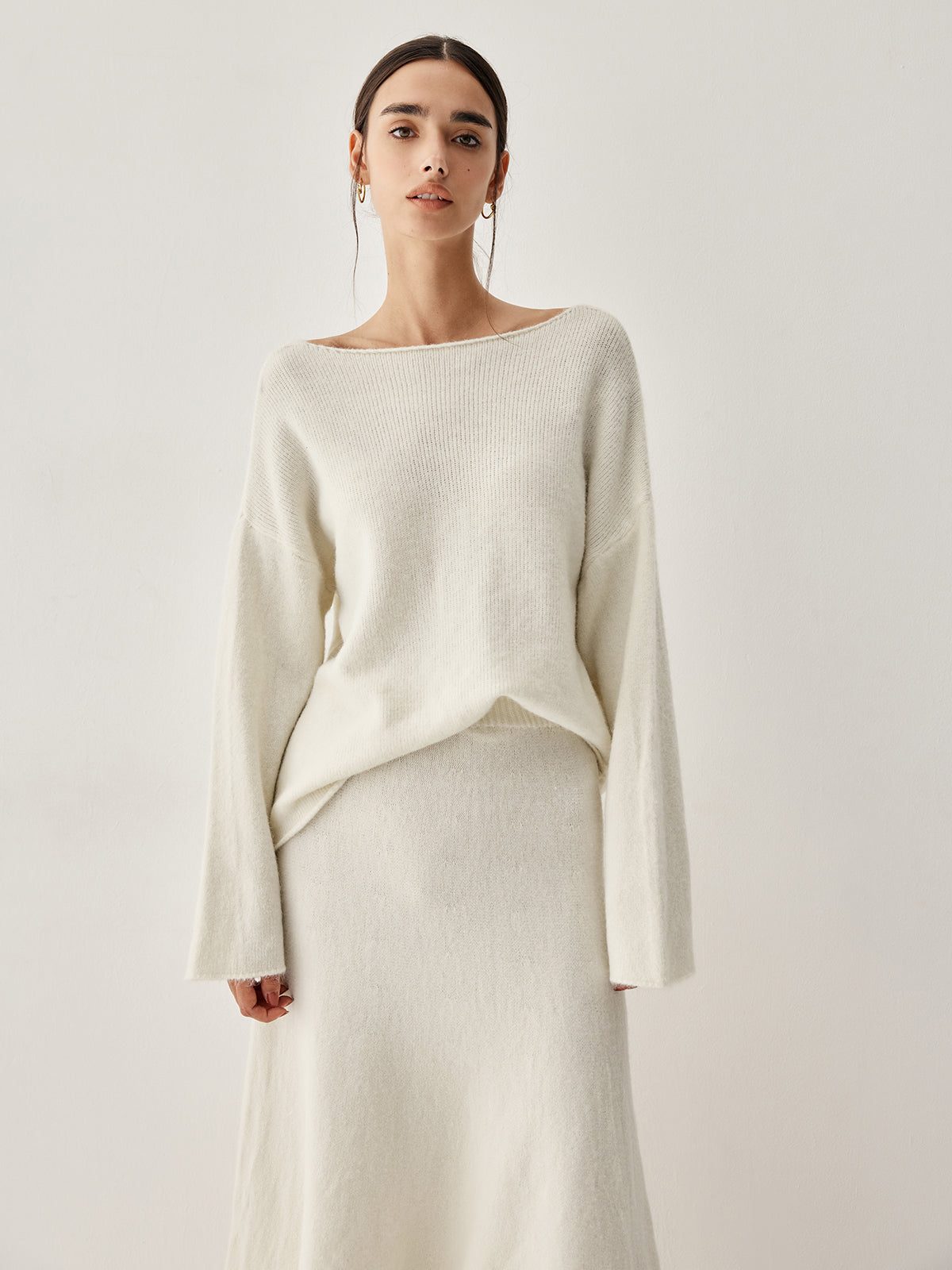 Jehanne cream sweater and skirt set, close-up of the bell cuffs and rolled hem