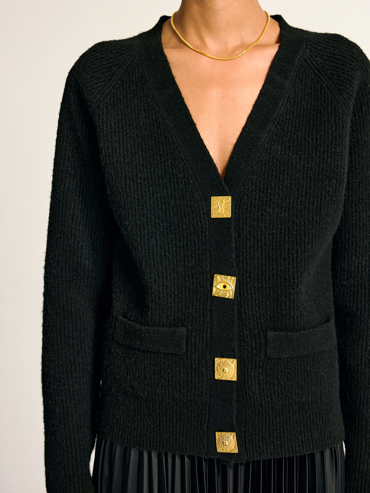 Judith black gold-button wool-blend cardigan, close-up of the hip welt detail