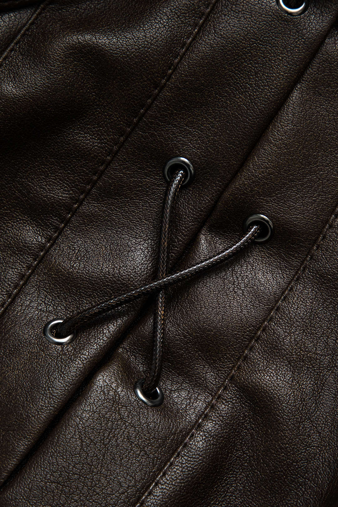 Lea Chocolate jacket, close-up of the crossed cord and gunmetal eyelets