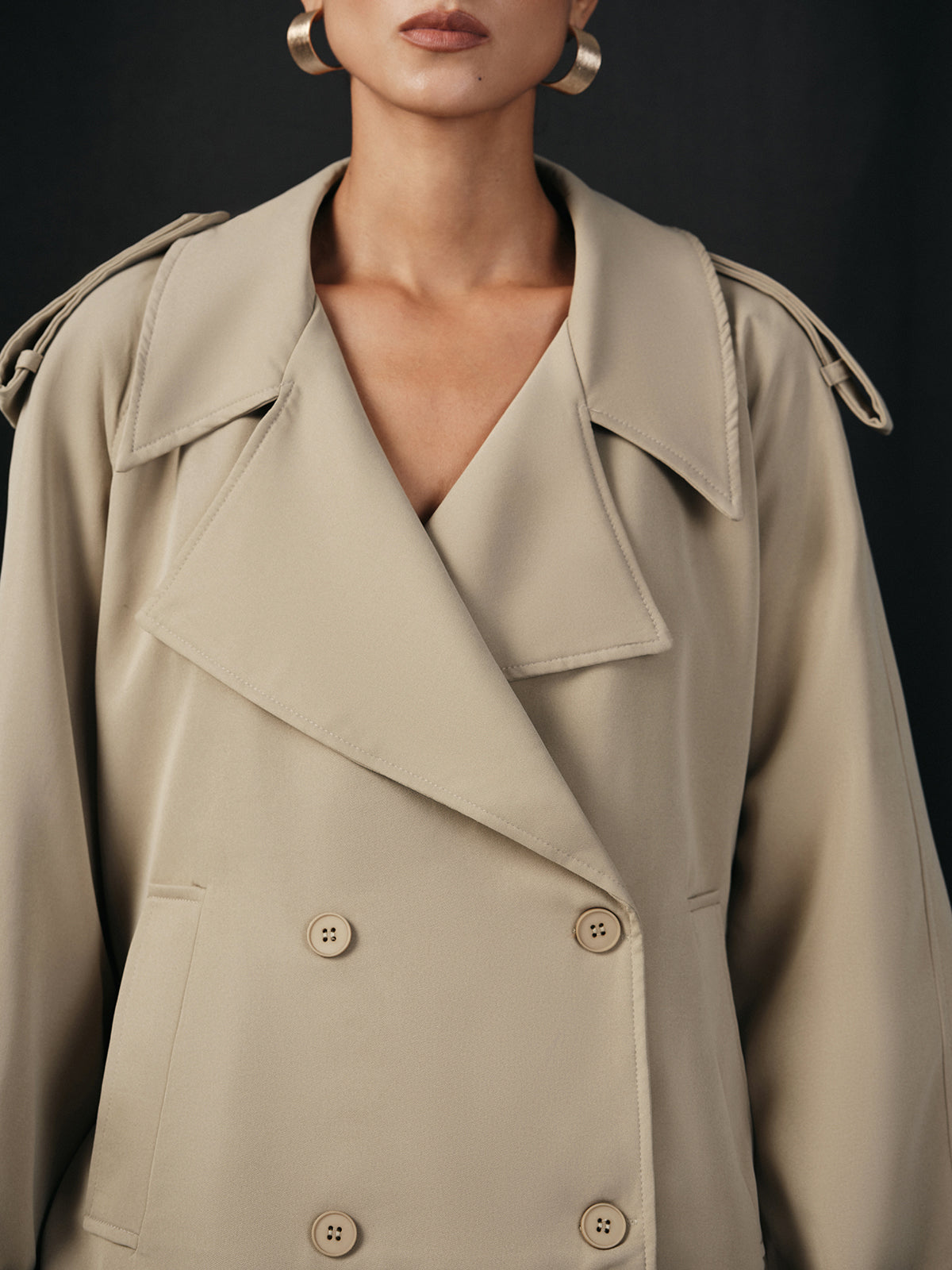 Close view of the wide lapels, epaulettes and buttons on a khaki jacket