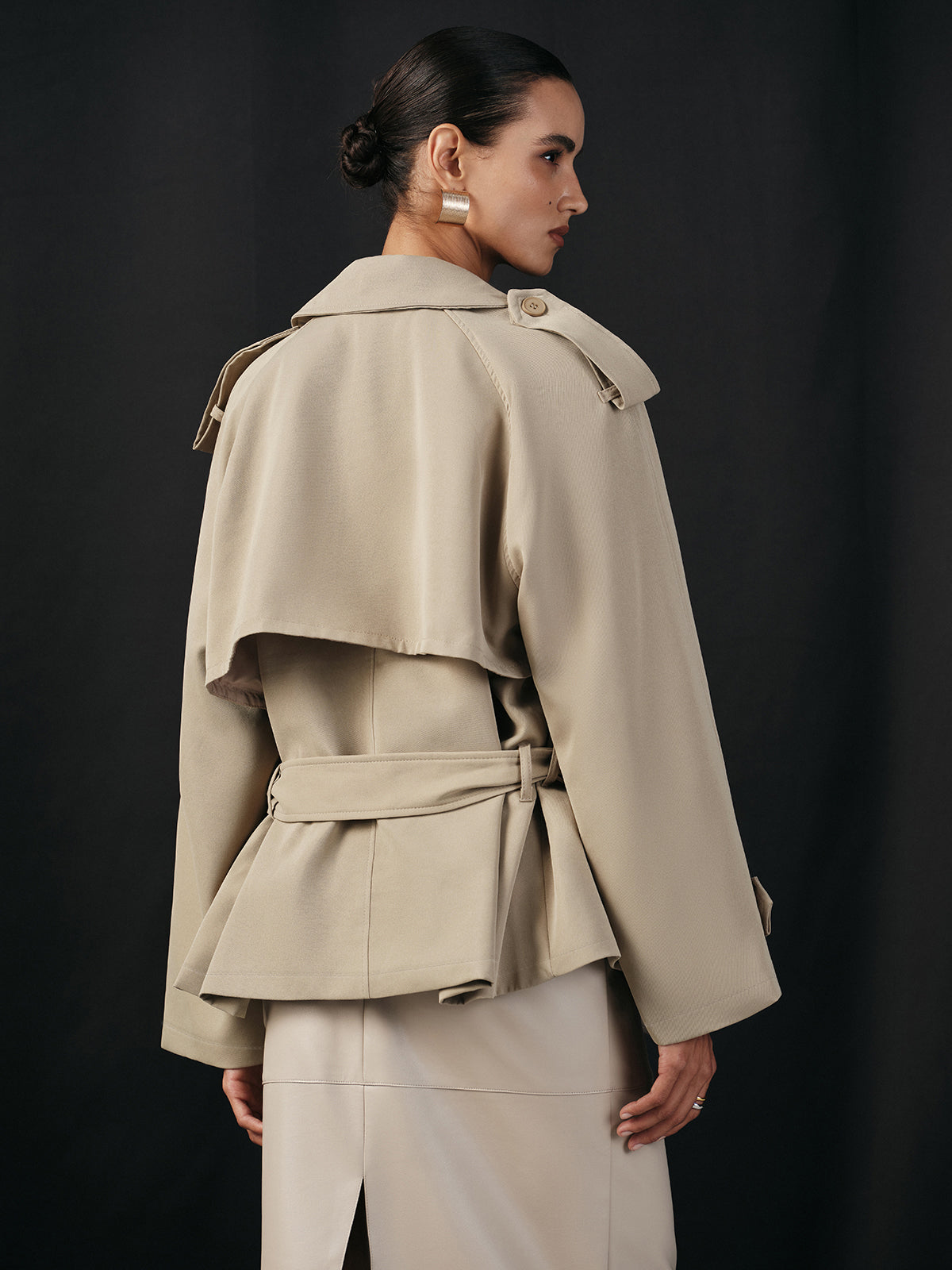 Khaki tie-waist jacket from the back, showing the storm flap and belt