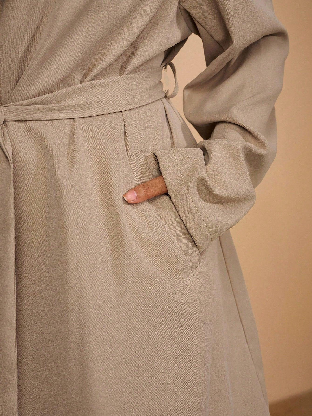Close-up of the hip pocket on the Mathilde khaki trench coat