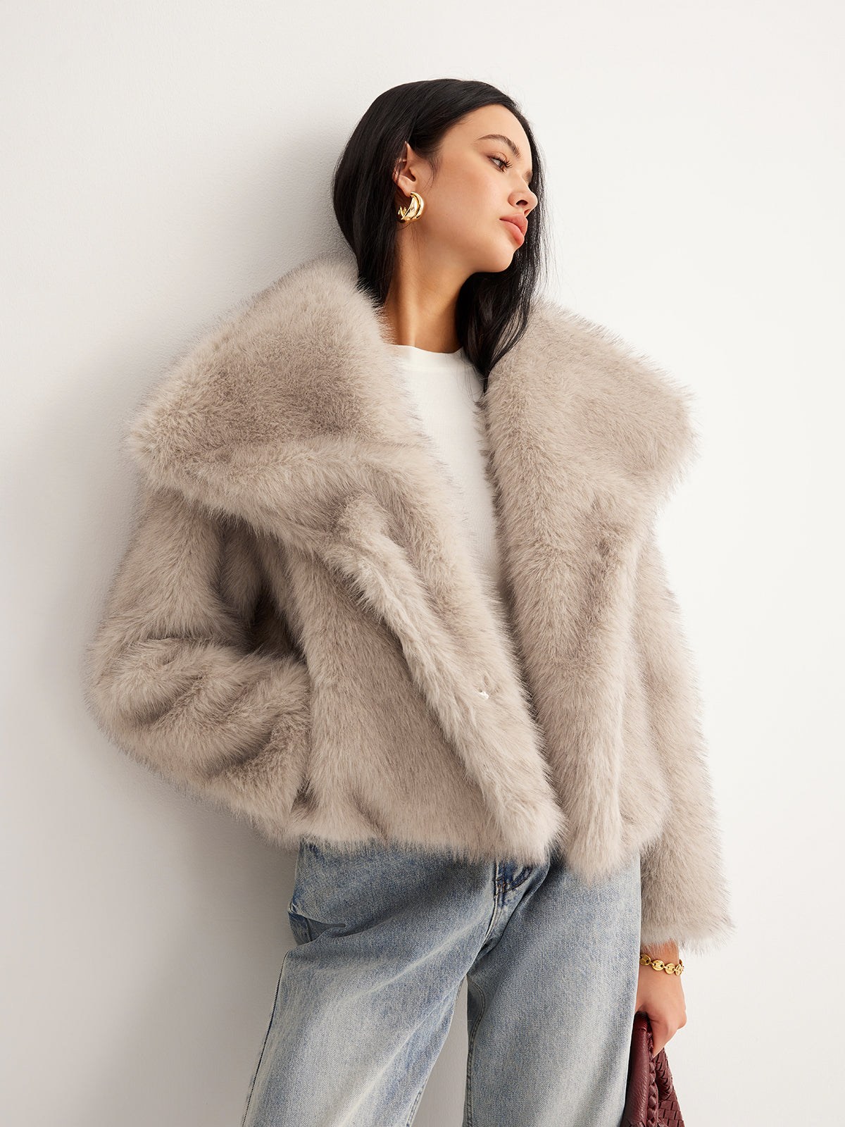 Micheline cream faux fur jacket worn open over a white top, front view showing the hip-length cut
