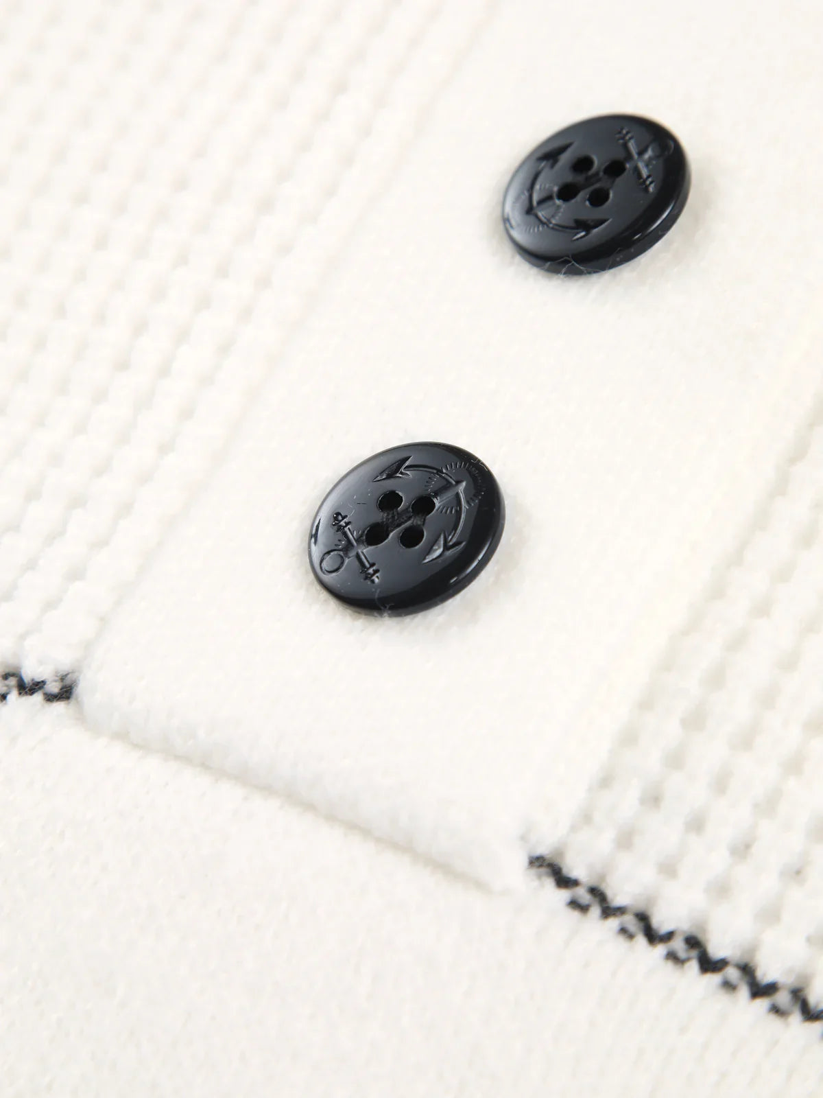 Close-up of the navy buttons and contrast stitch on the Mireille sweater
