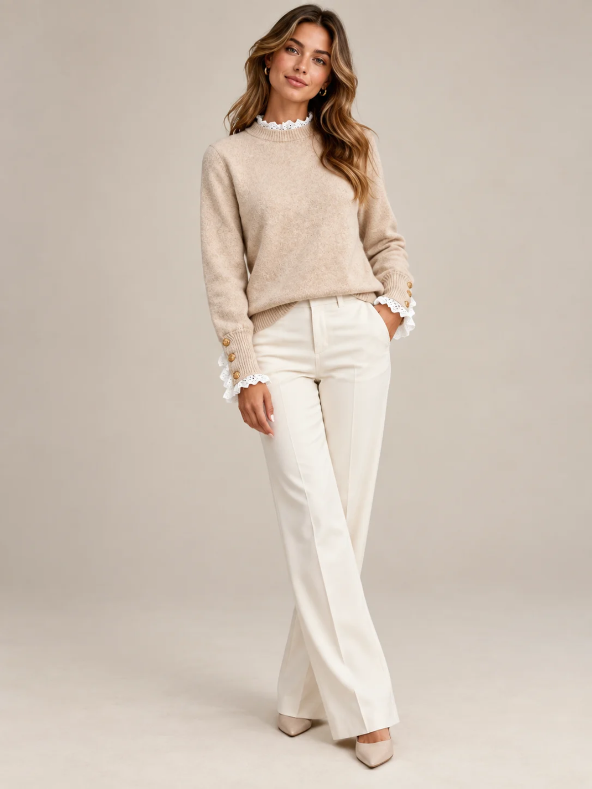Nadine beige knit sweater worn with cream trousers, full-length view