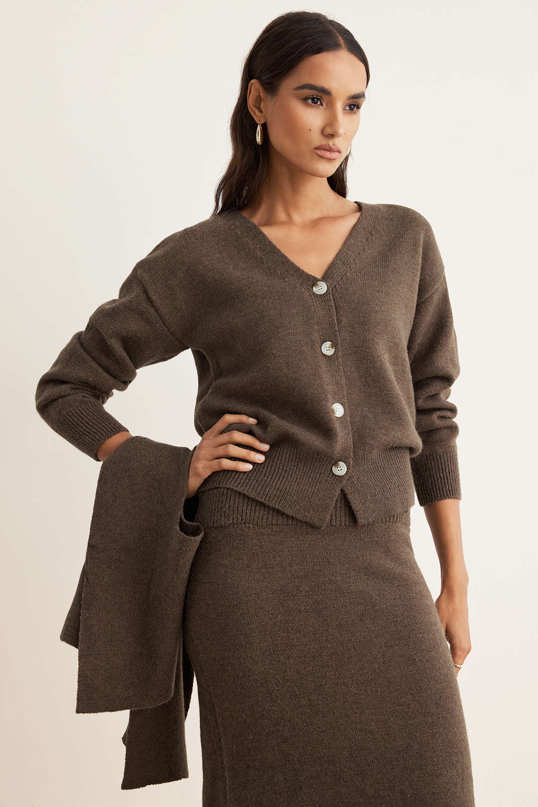Brown knit two-piece showing the ribbed waistband on the midi skirt
