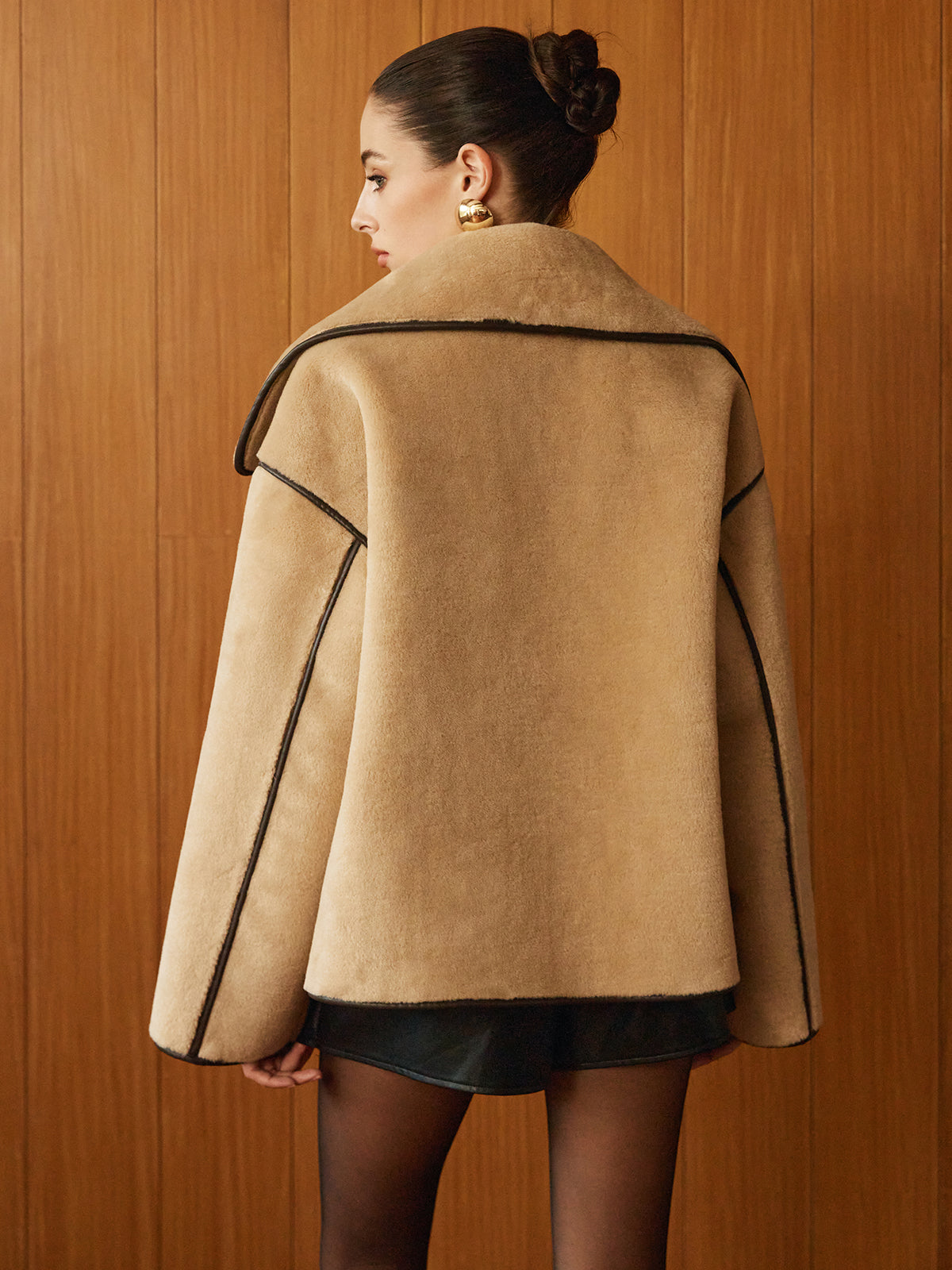 Beige oversized-collar jacket seen from behind, showing the wide back