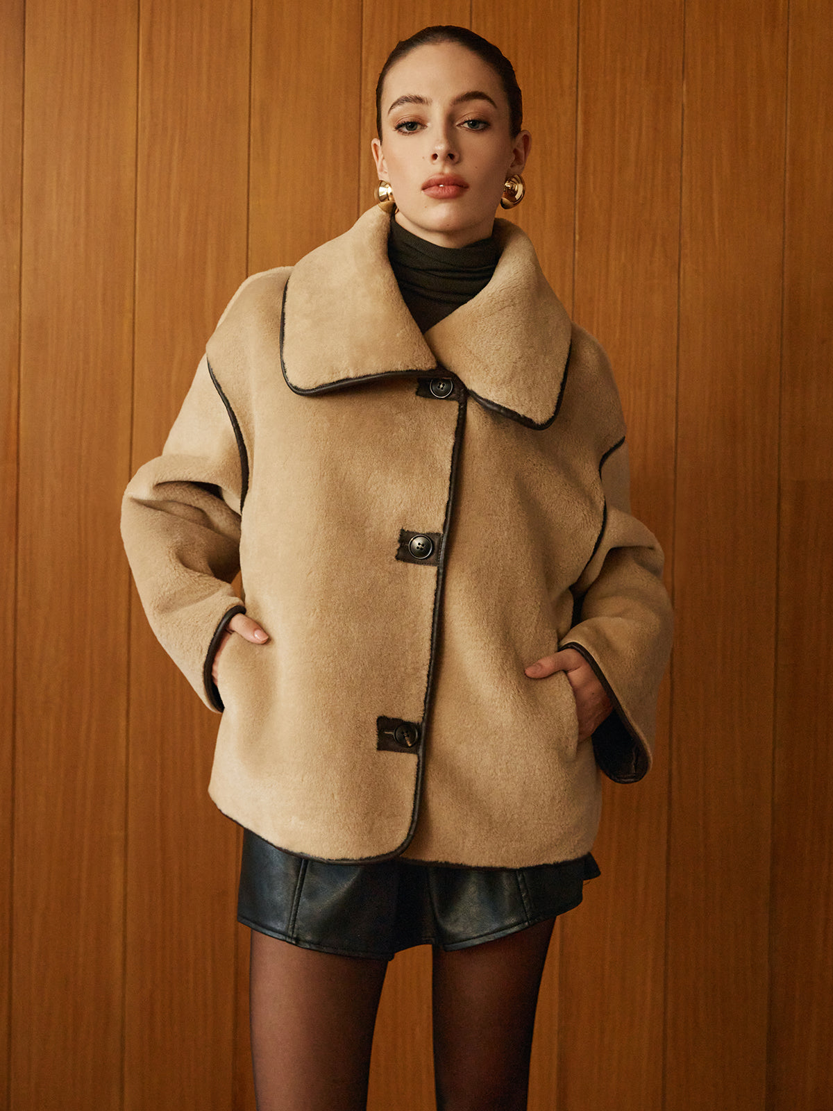 Beige jacket worn with hands in the front pockets, front view