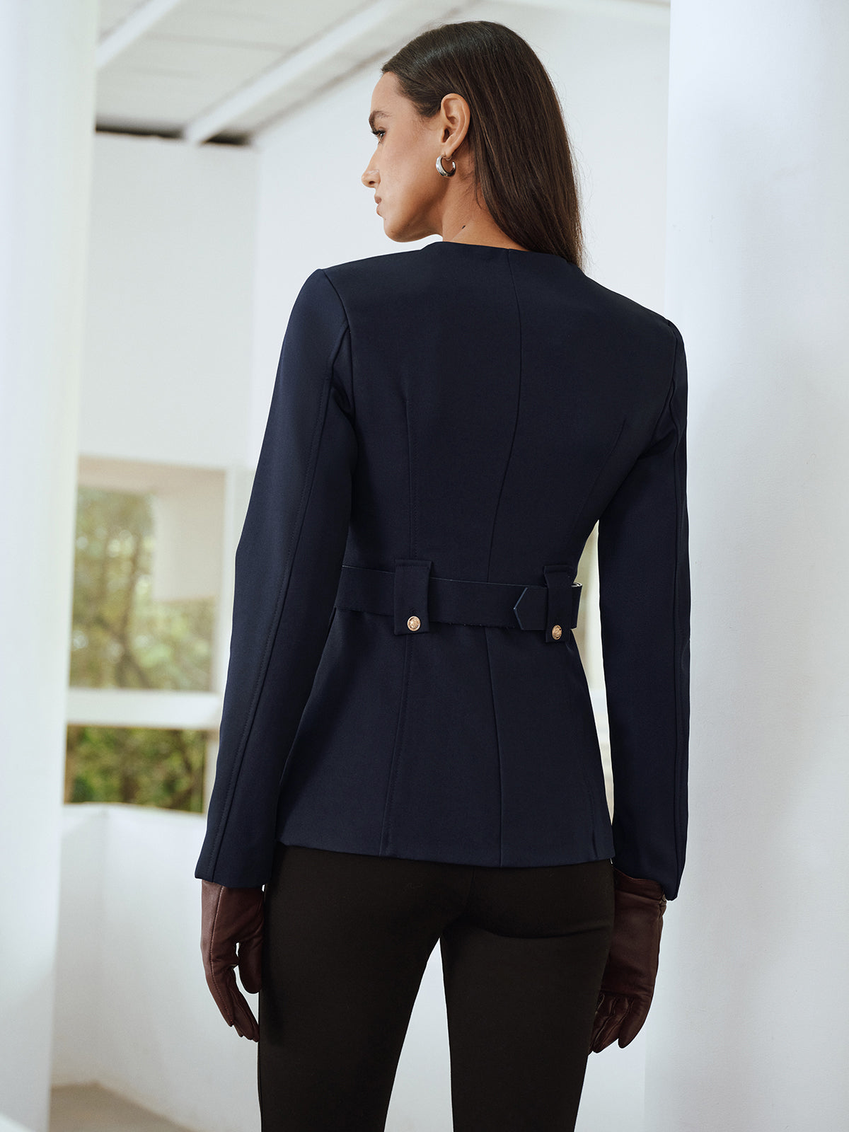 Navy blue fitted jacket from the back, showing the defined waist