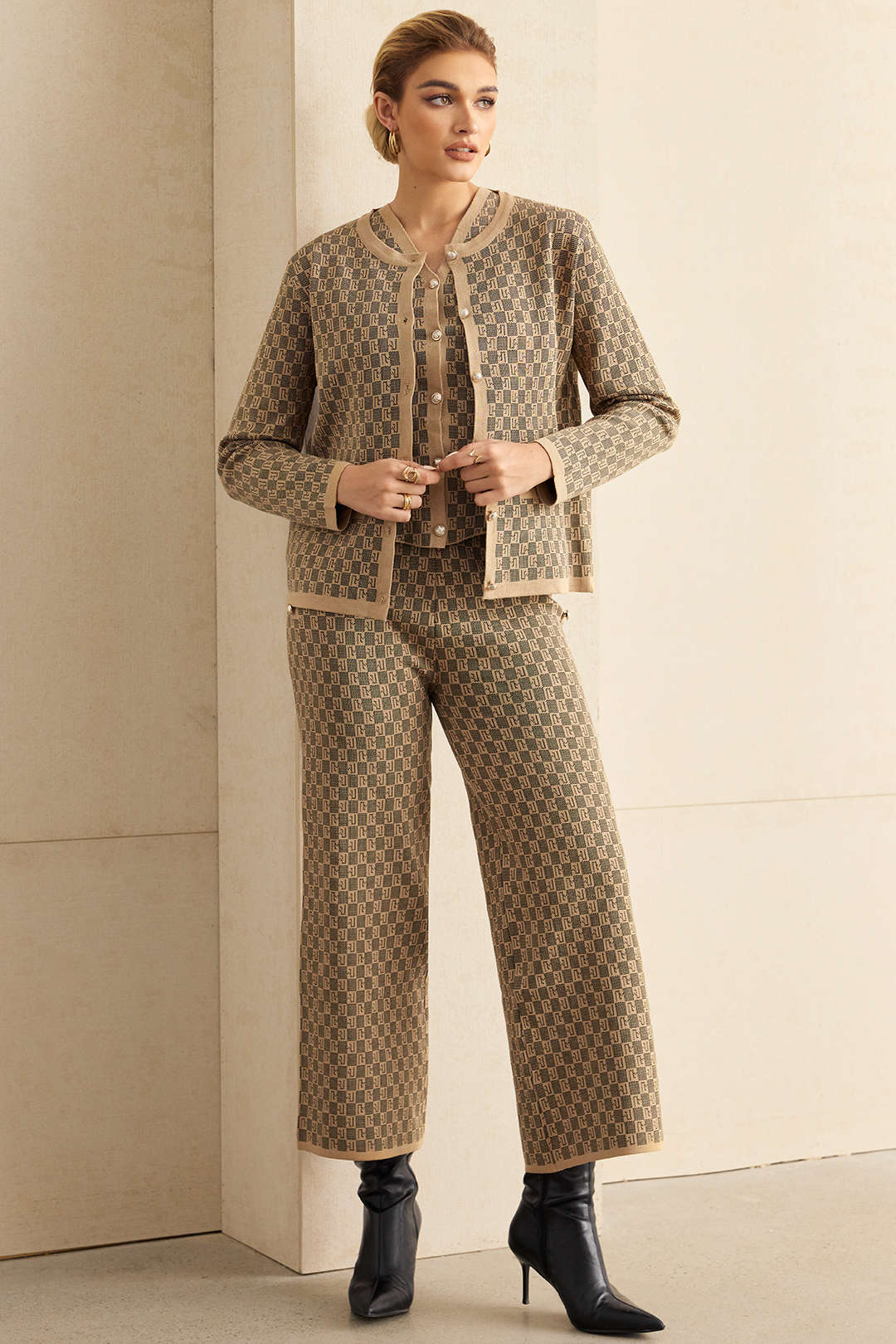 Woman wearing a beige jacquard knit cardigan, waistcoat and wide-leg trousers