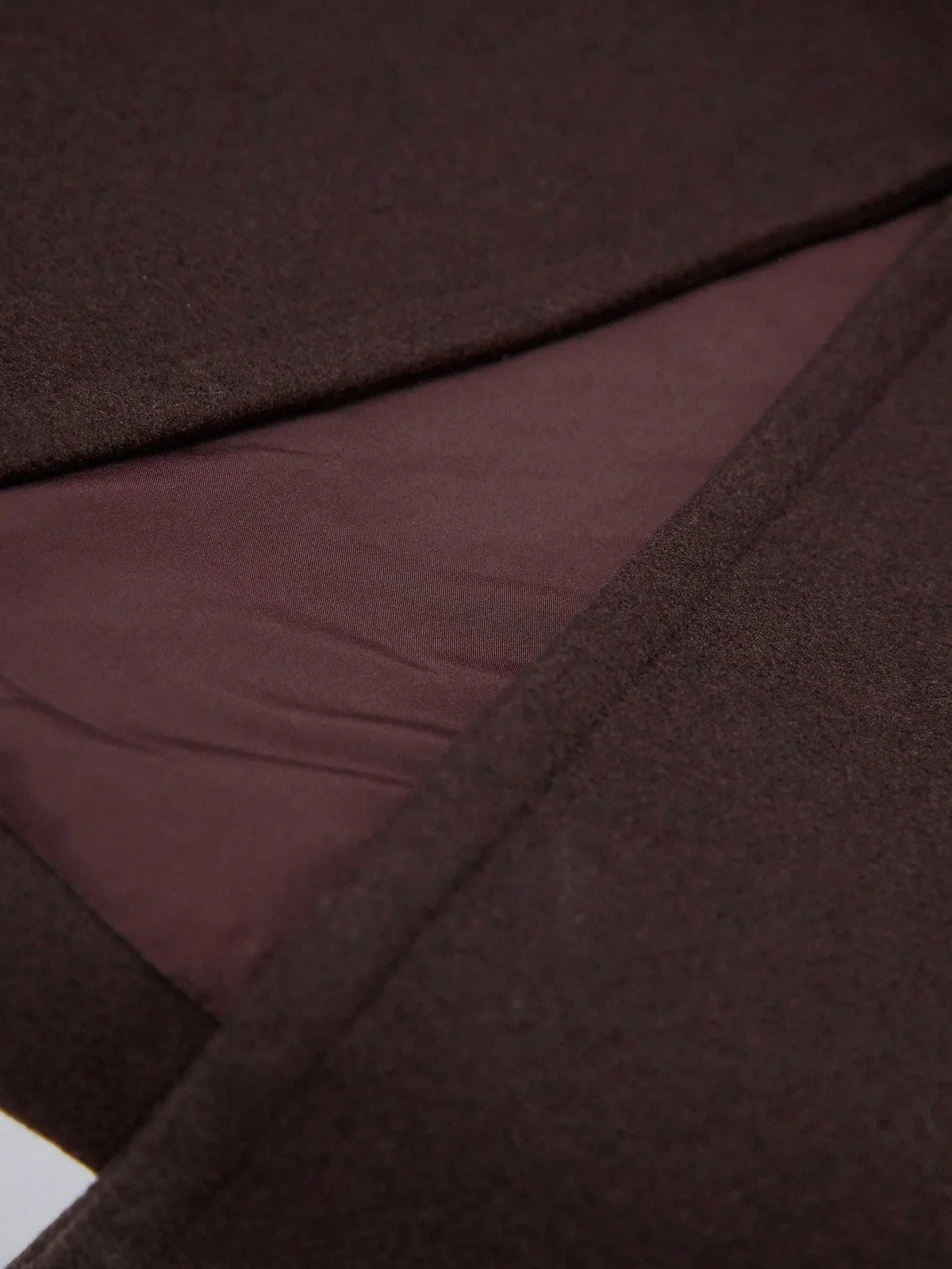 Close-up of the coffee brown fabric of the Sabine coat