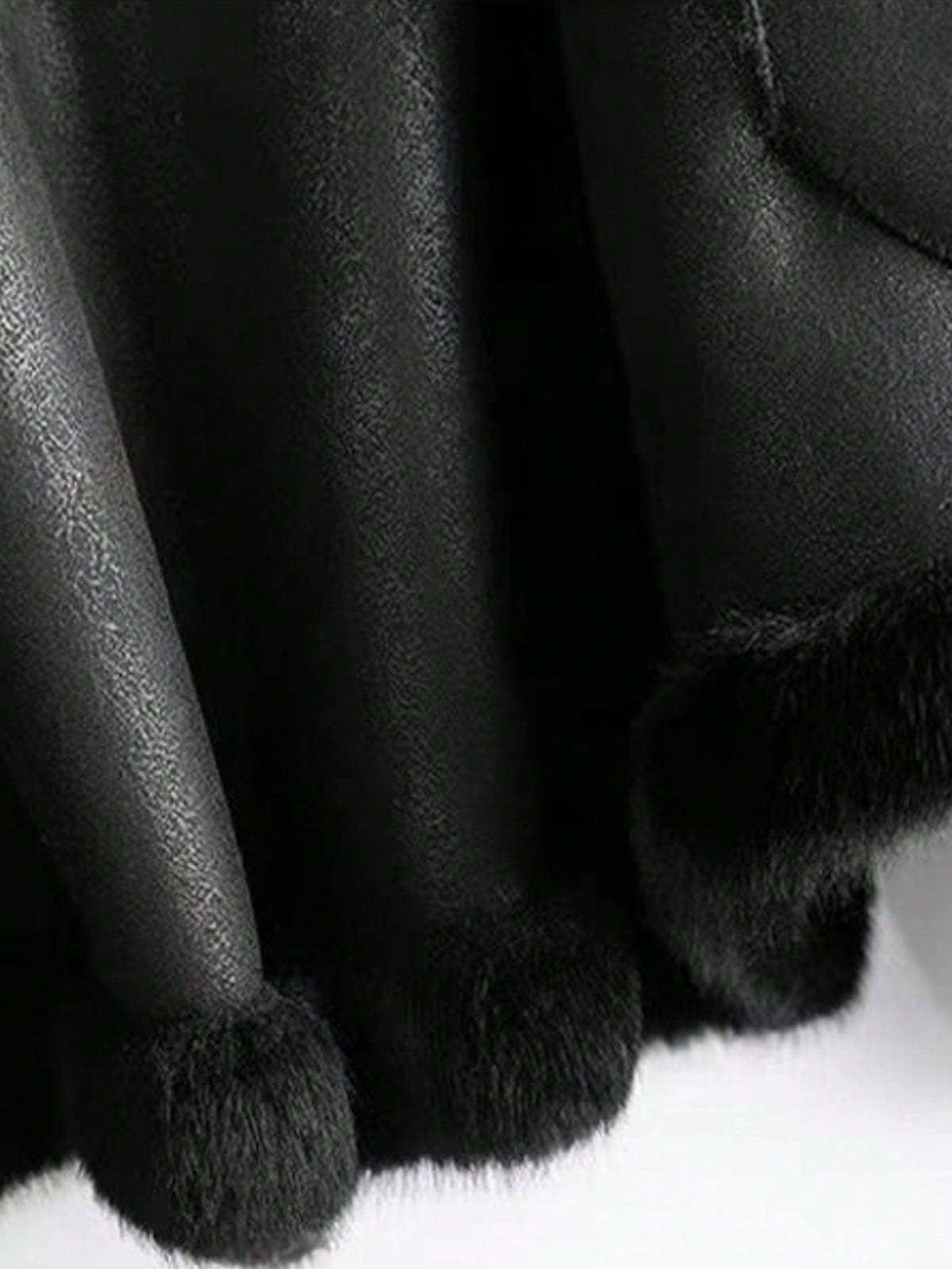 Close-up of the hem and cuff on the Solange black faux fur coat