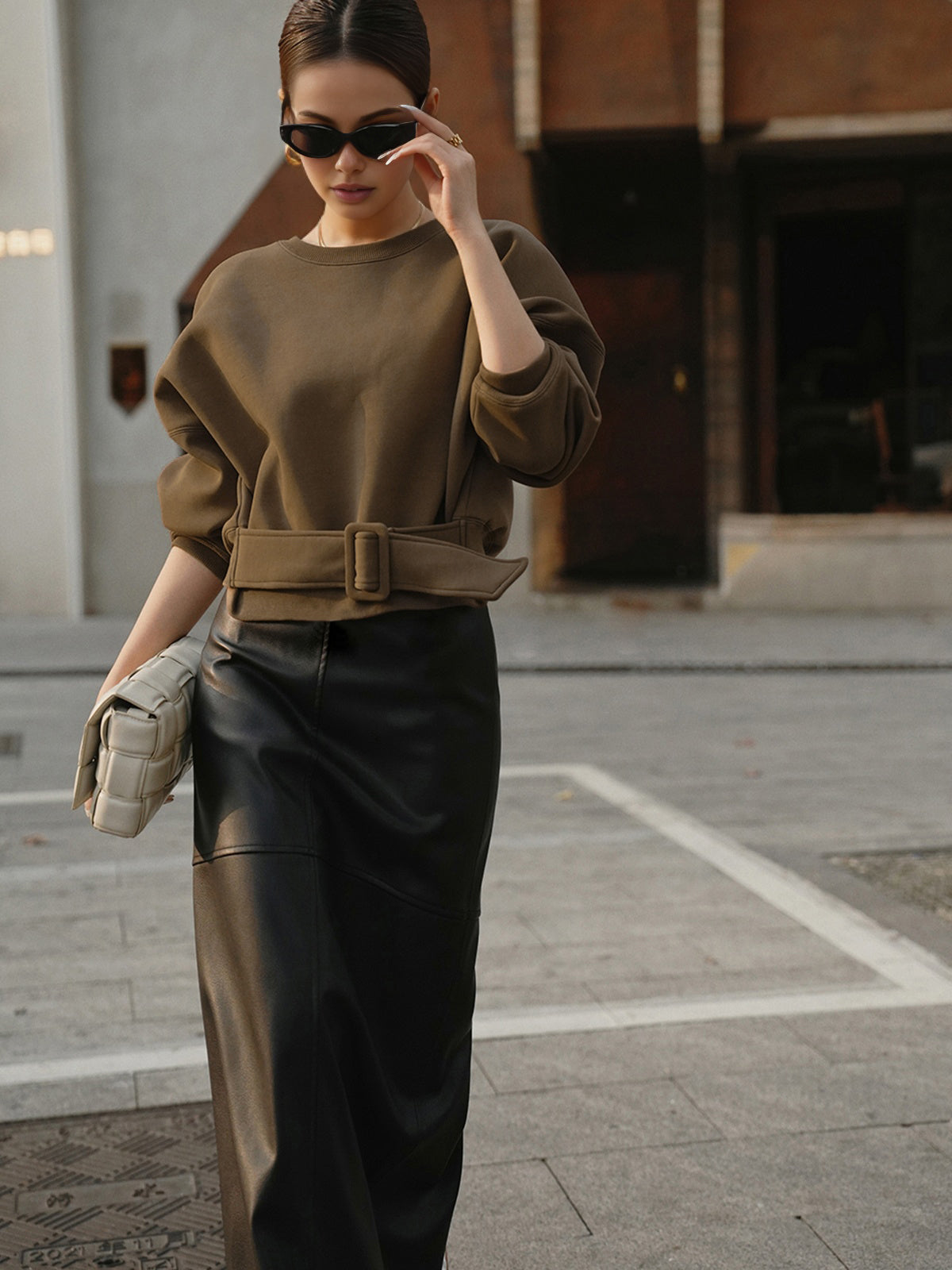 Stephanie brown belted cropped sweatshirt, outdoor front view showing the belt buckle