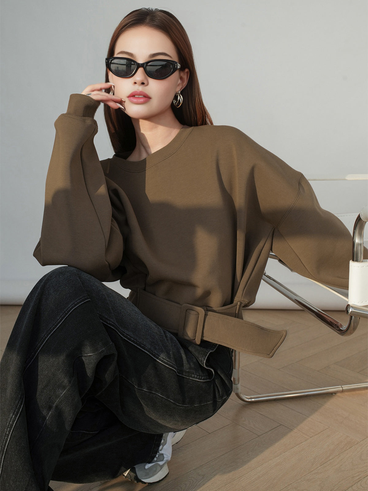 Stephanie brown belted cropped sweatshirt, close-up of the ribbed cuff and loose belt tail