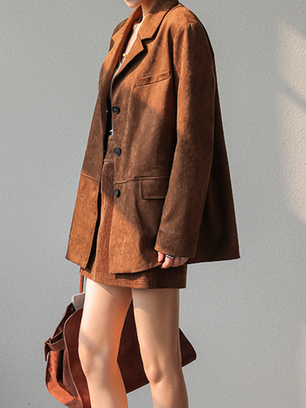 Ursule Brown blazer, side view showing the flap hip pocket