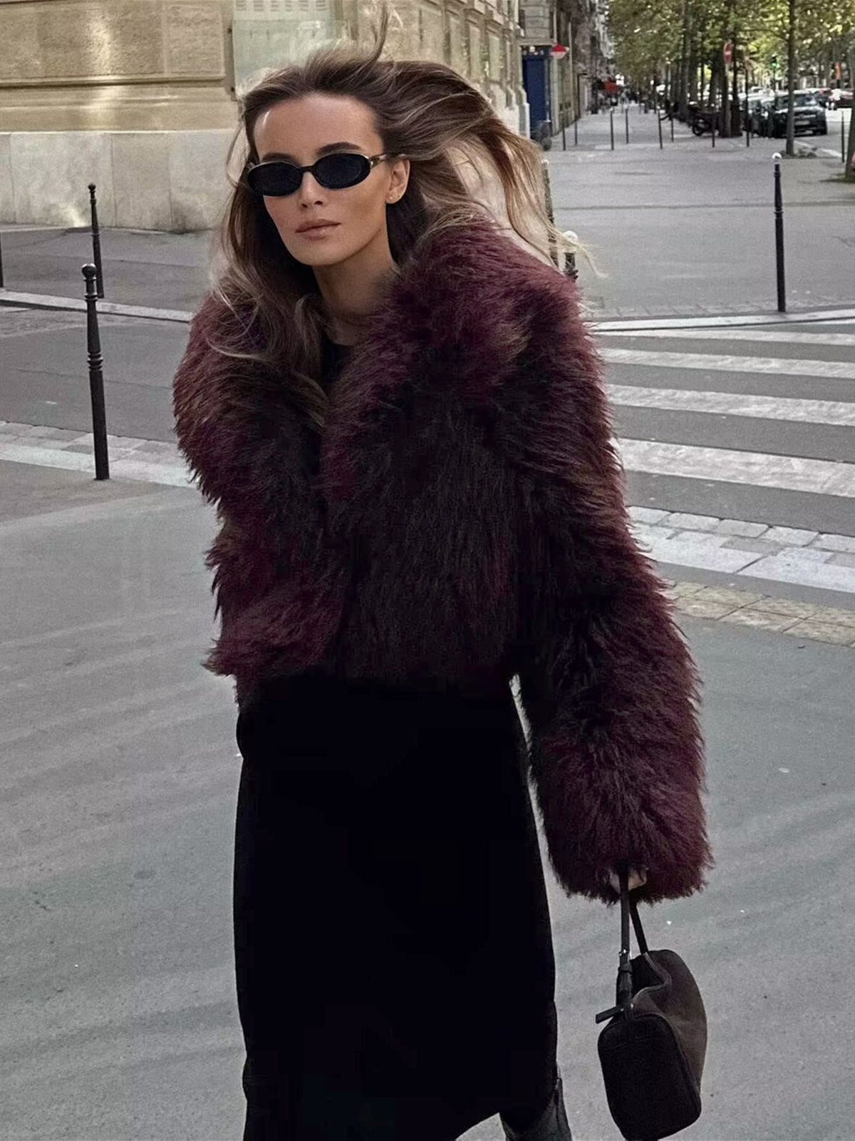 Wilhelmine Burgundy shaggy jacket worn open over a black dress, three-quarter view